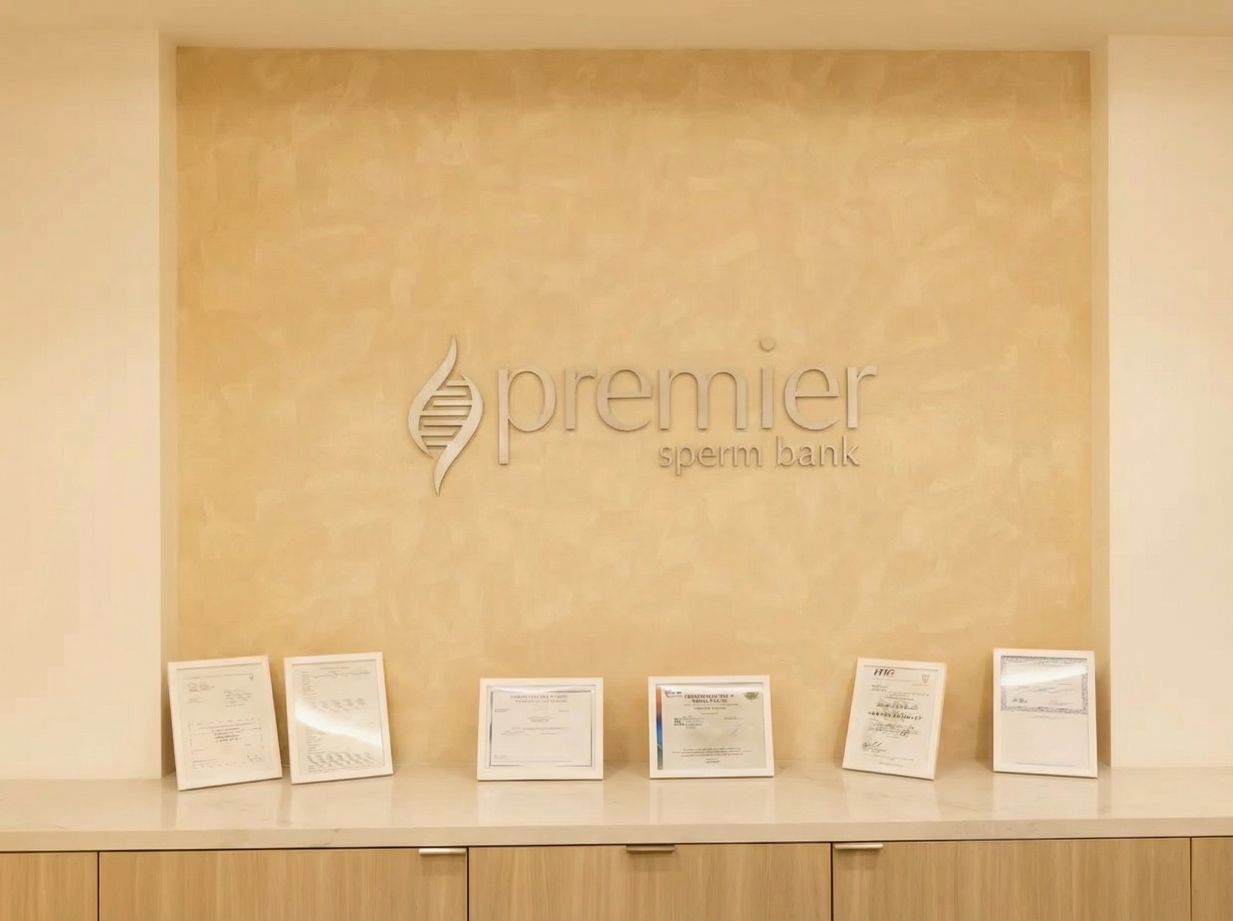 Premier Sperm Bank lobby wall with logo and framed certificates