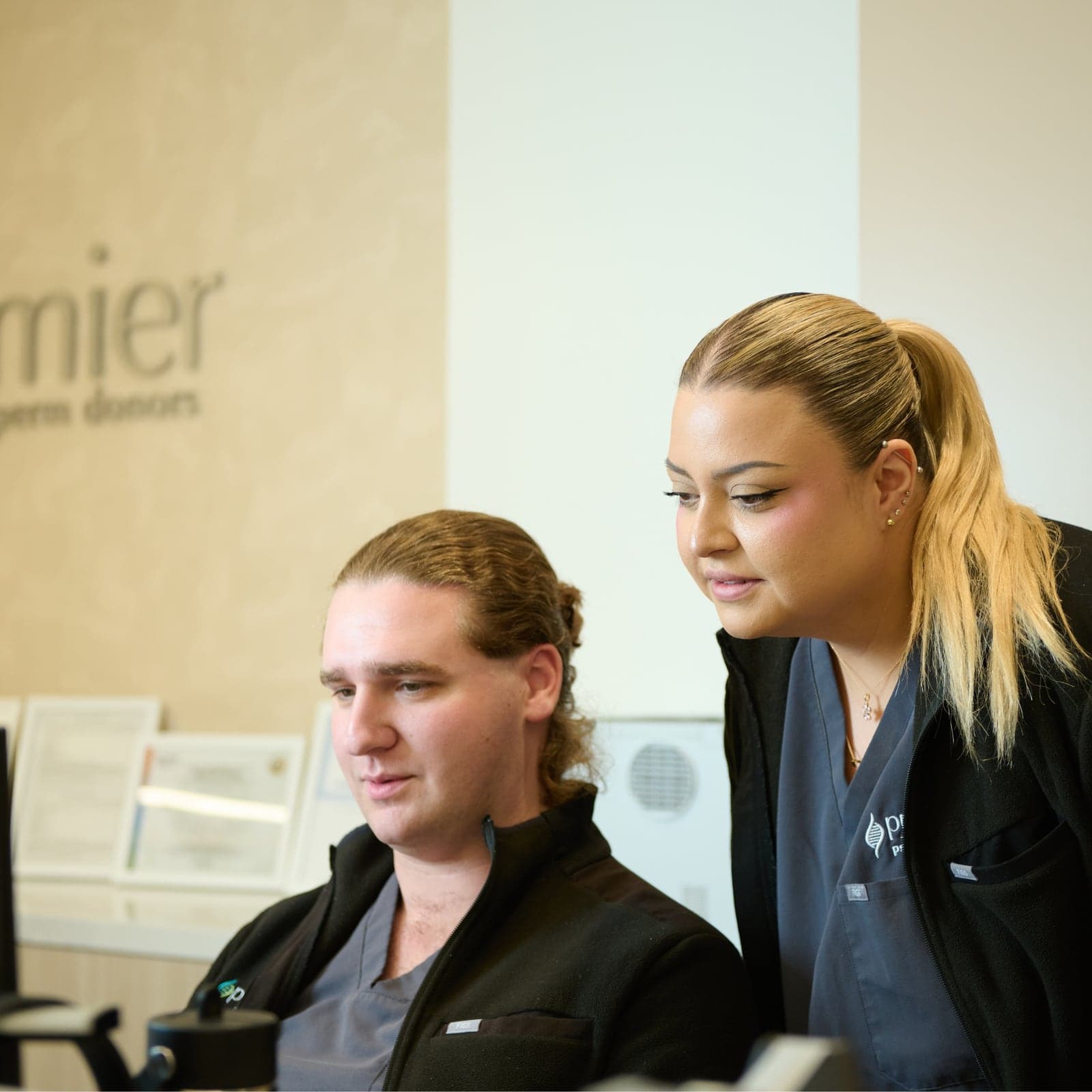 Premier Sperm Bank staff collaborating at a workstation