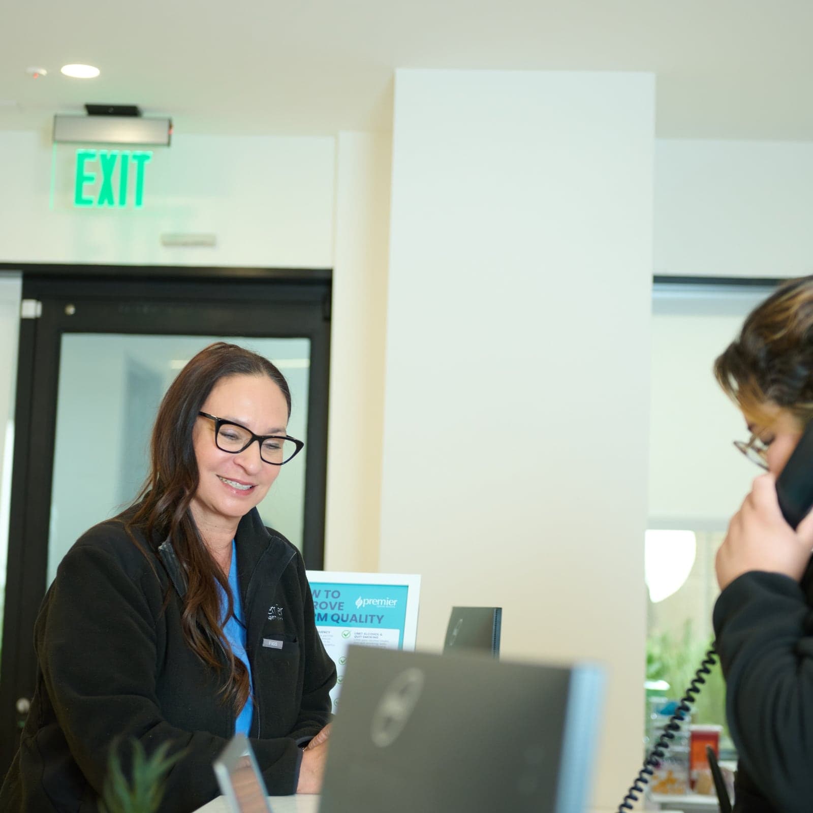 Premier Sperm Bank staff member assisting at the front desk